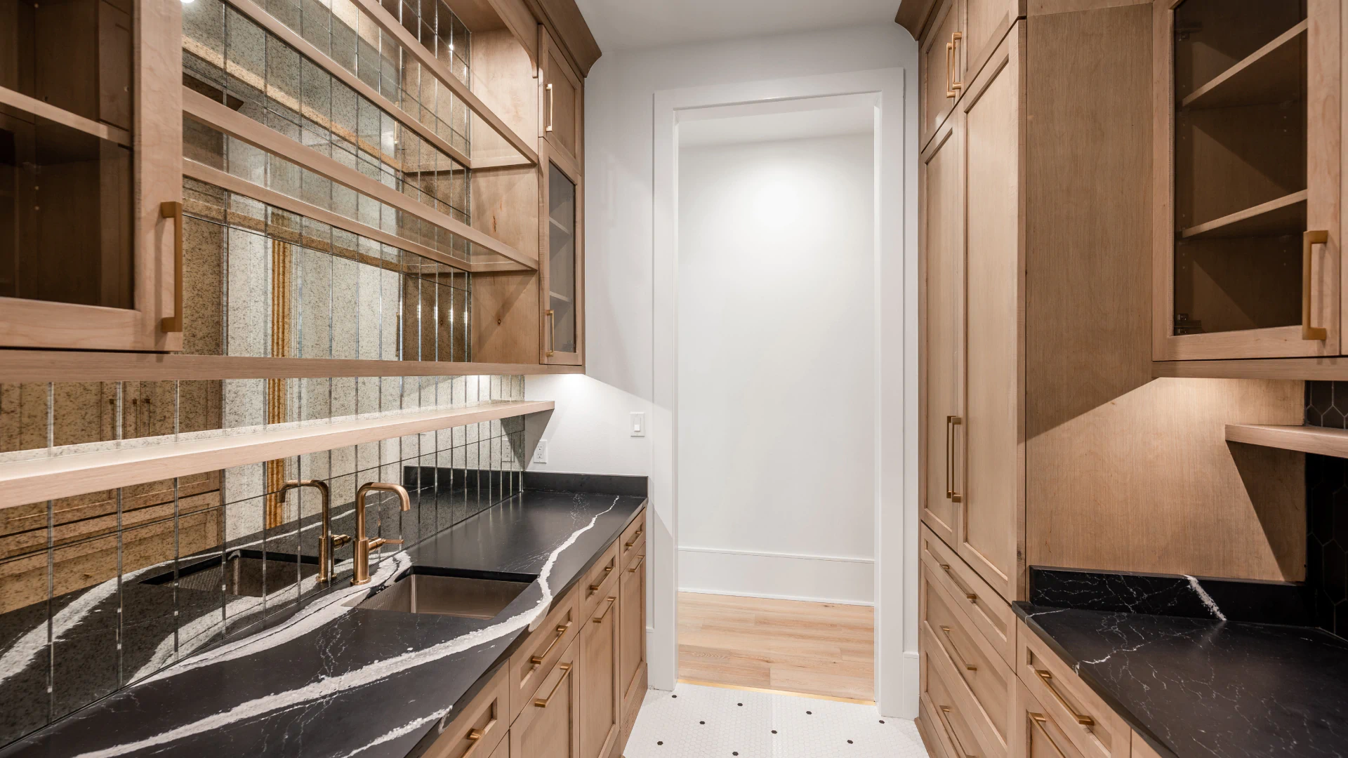 luxurious kitchen with small alley way and brown cabinets